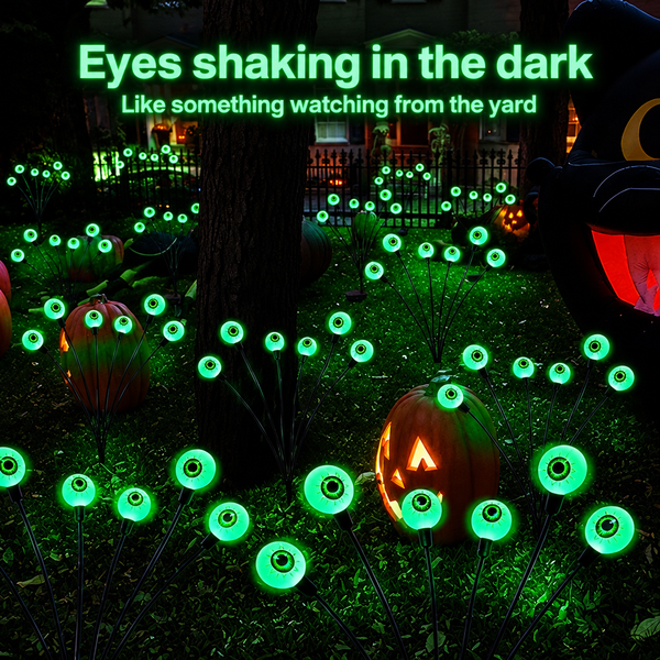 Eyes glowing across a decorated front yard with jack-o-lanterns